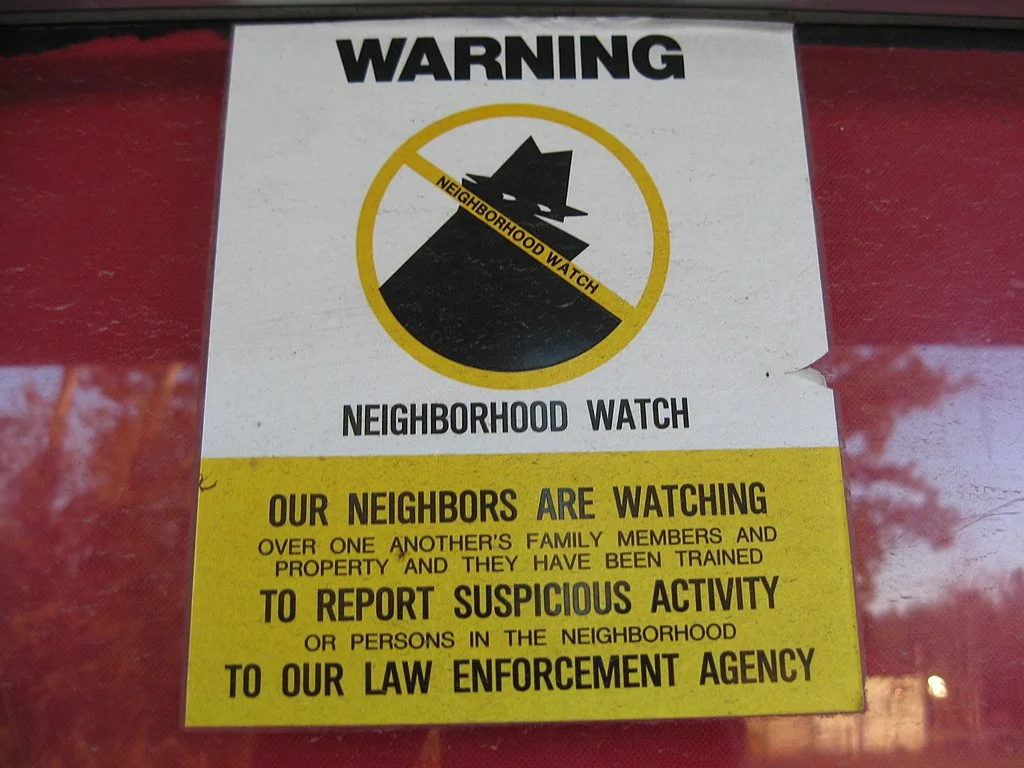 A neighborhood watch sign—evidence of local community care and safety culture.